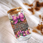 Christmas-themed tumbler with a pink bow and presents on a textured surface