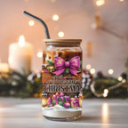 Christmas-themed glass with a straw, decorated with bows and 'Merry Christmas' text, against a festive background.