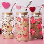 Three glass jars with decorative designs on a pink background with heart decorations.