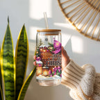 Hand holding a Merry Christmas-themed tumbler with decorative elements and text.