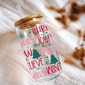 Clear tumbler with Christmas-themed text and designs on a textured surface