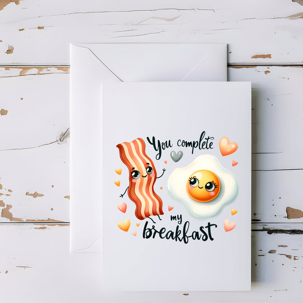Card with cartoon bacon and egg design on a wooden surface