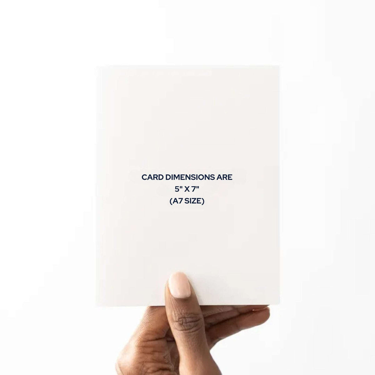 Hand holding a white card with dimensions text on a white background