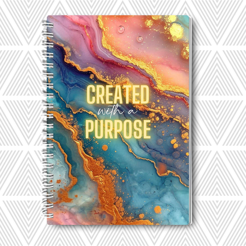 Journal with colorful abstract design and 'Created with a Purpose' text on a white background