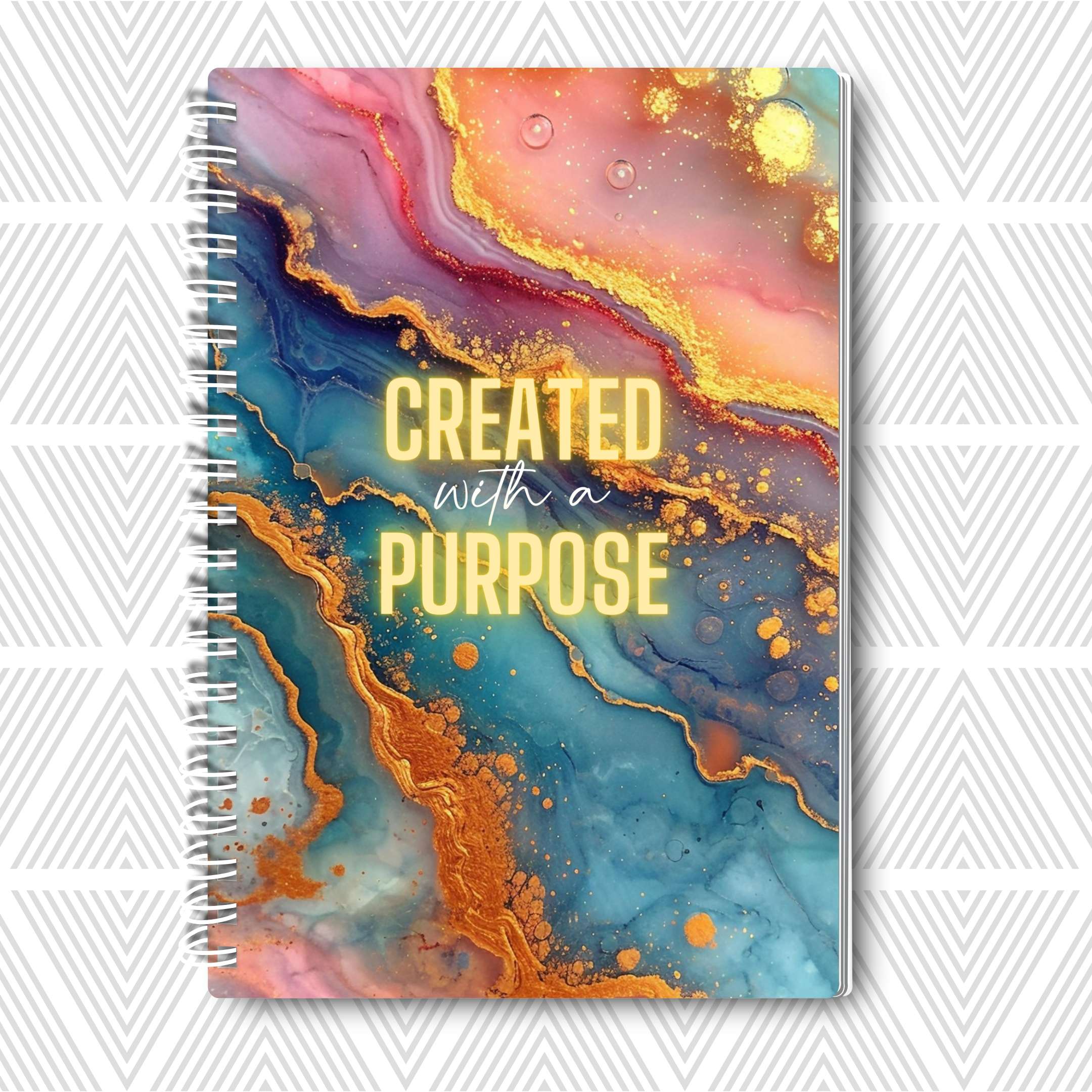 Journal with colorful abstract design and 'Created with a Purpose' text on a white background