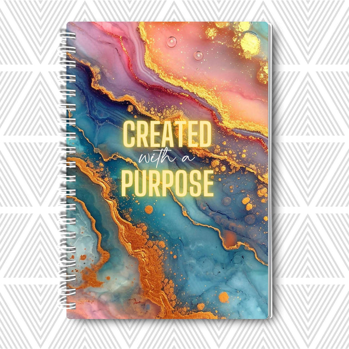 Journal with colorful abstract design and 'Created with a Purpose' text on a white background
