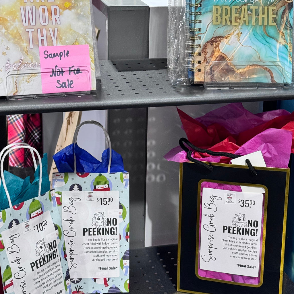 Assorted stationery items including notebooks and cards in a display case.