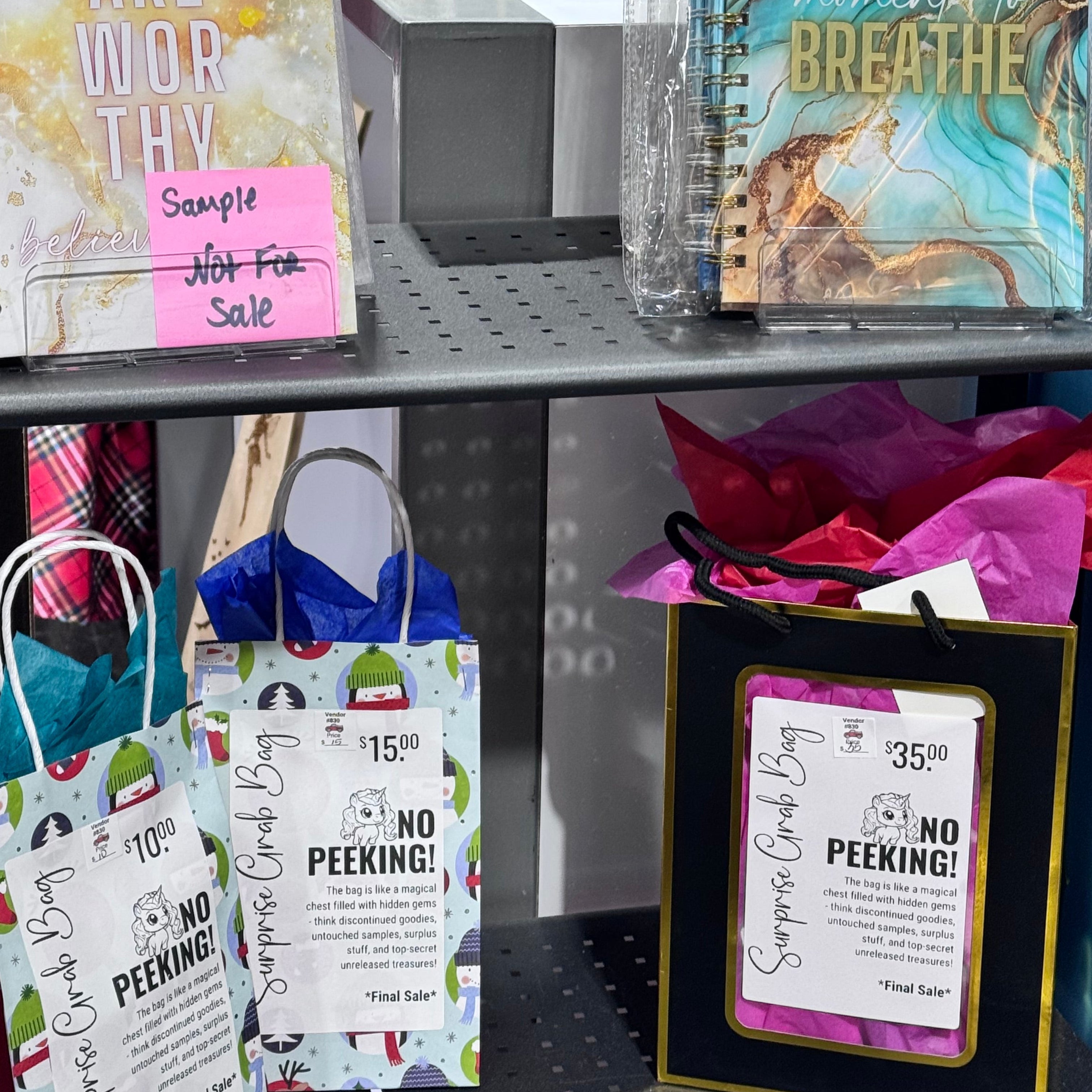 Assorted stationery items including notebooks and cards in a display case.