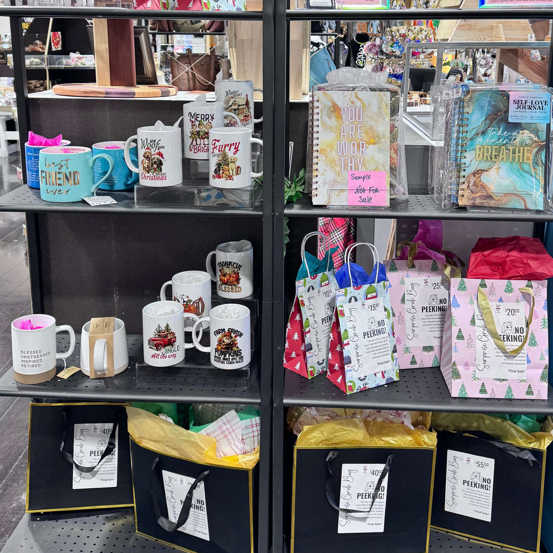 Display case with various merchandise including mugs, keychains, and postcards.