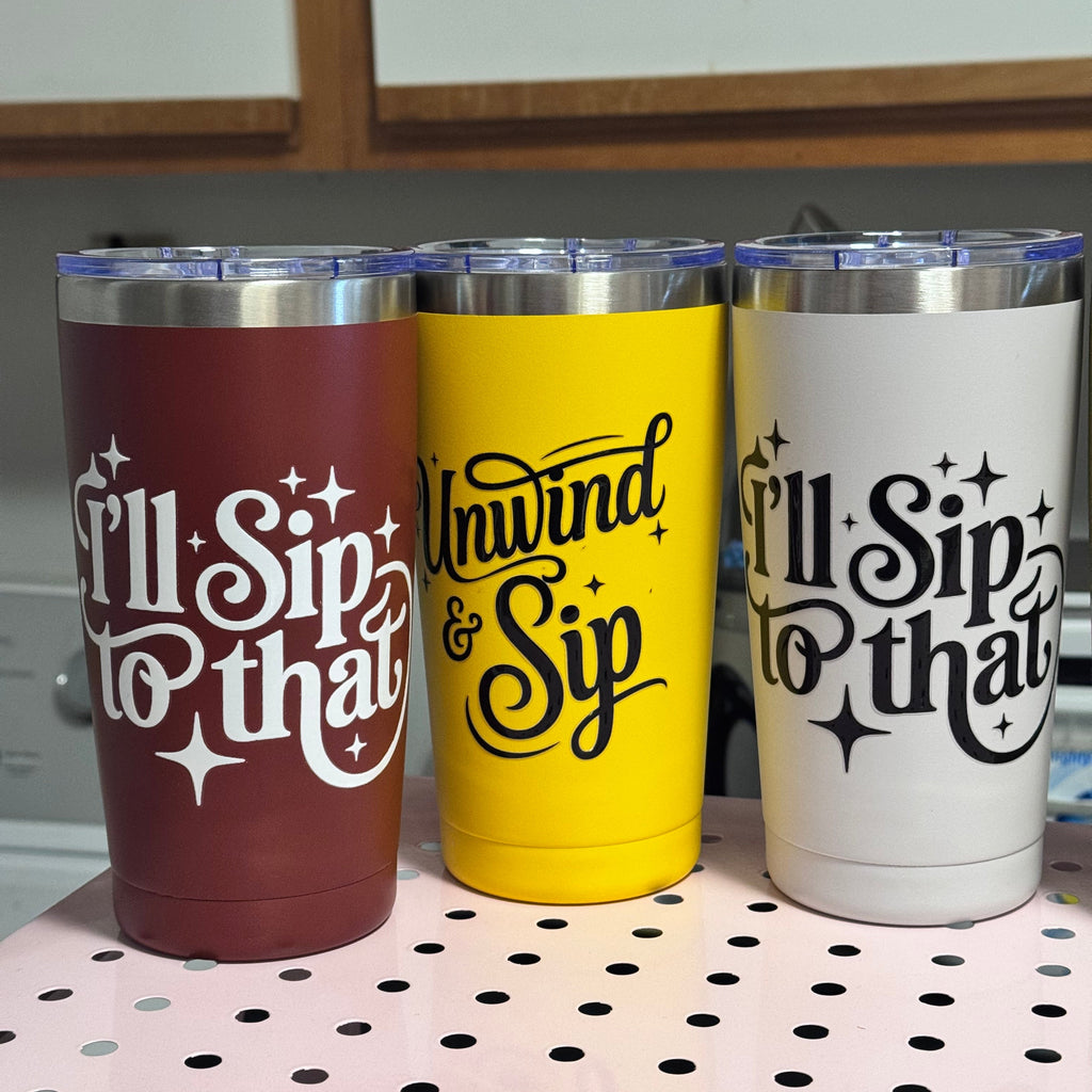 Three tumblers with 'I'll Sip to That' text design on a pegboard.