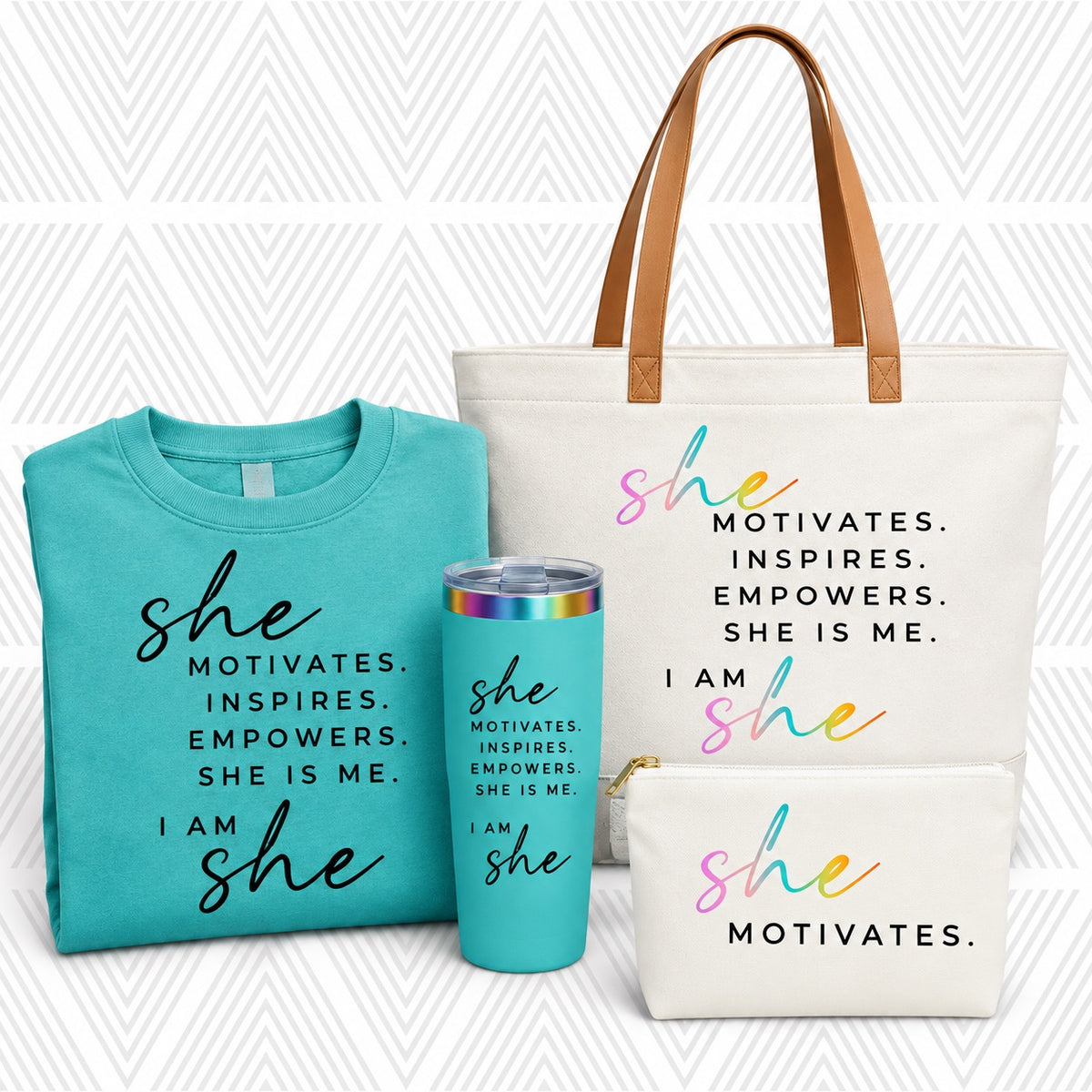 A coordinated gift set featuring a folded turquoise T-shirt, a matching turquoise tumbler with a rainbow lid, and two cream tote-style bags with tan handles, all printed with the phrase 'She Motivates.'