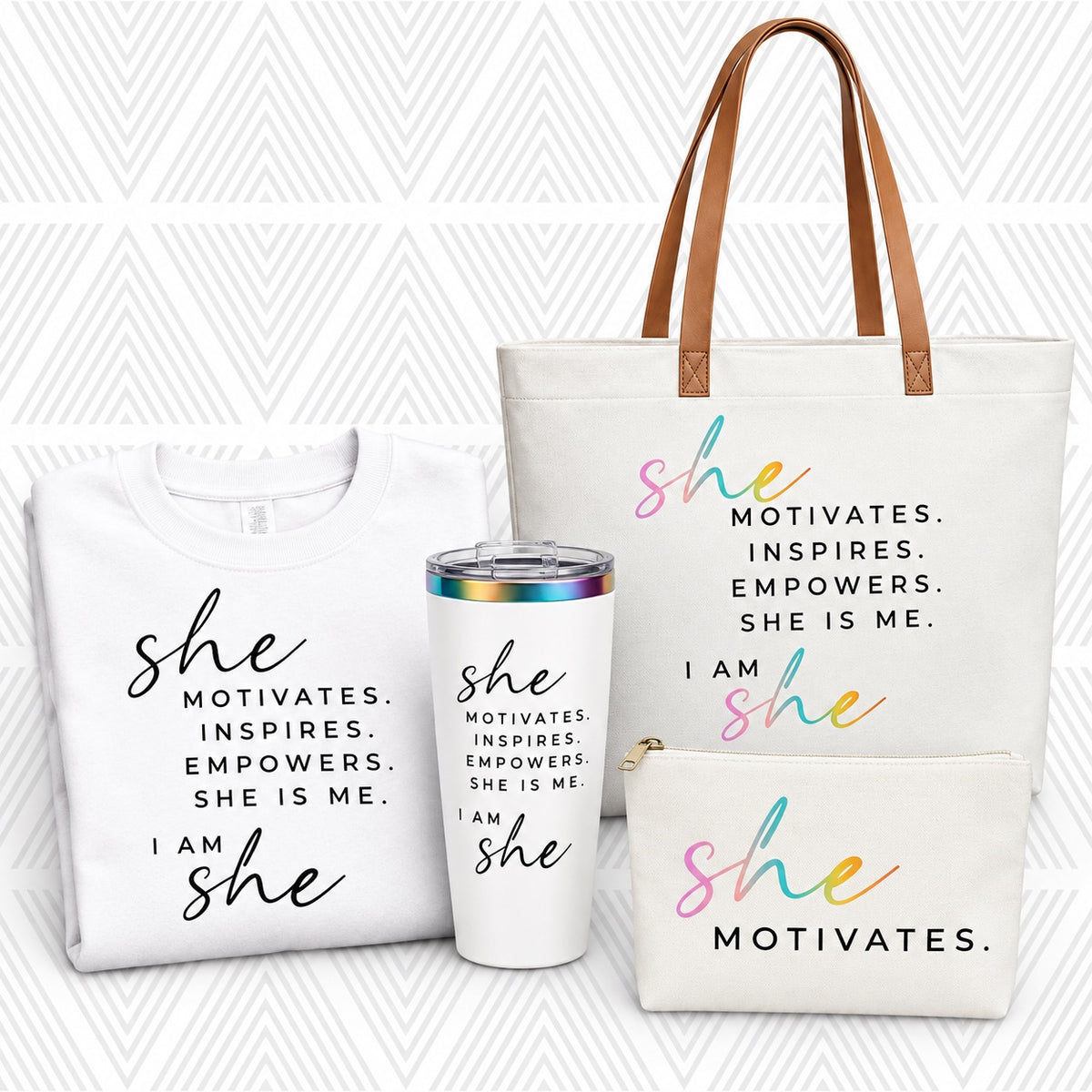 A coordinated gift set featuring a white tote bag, white sweatshirt, white tumbler, and white pouch with the phrase 'SHE MOTIVATES.'