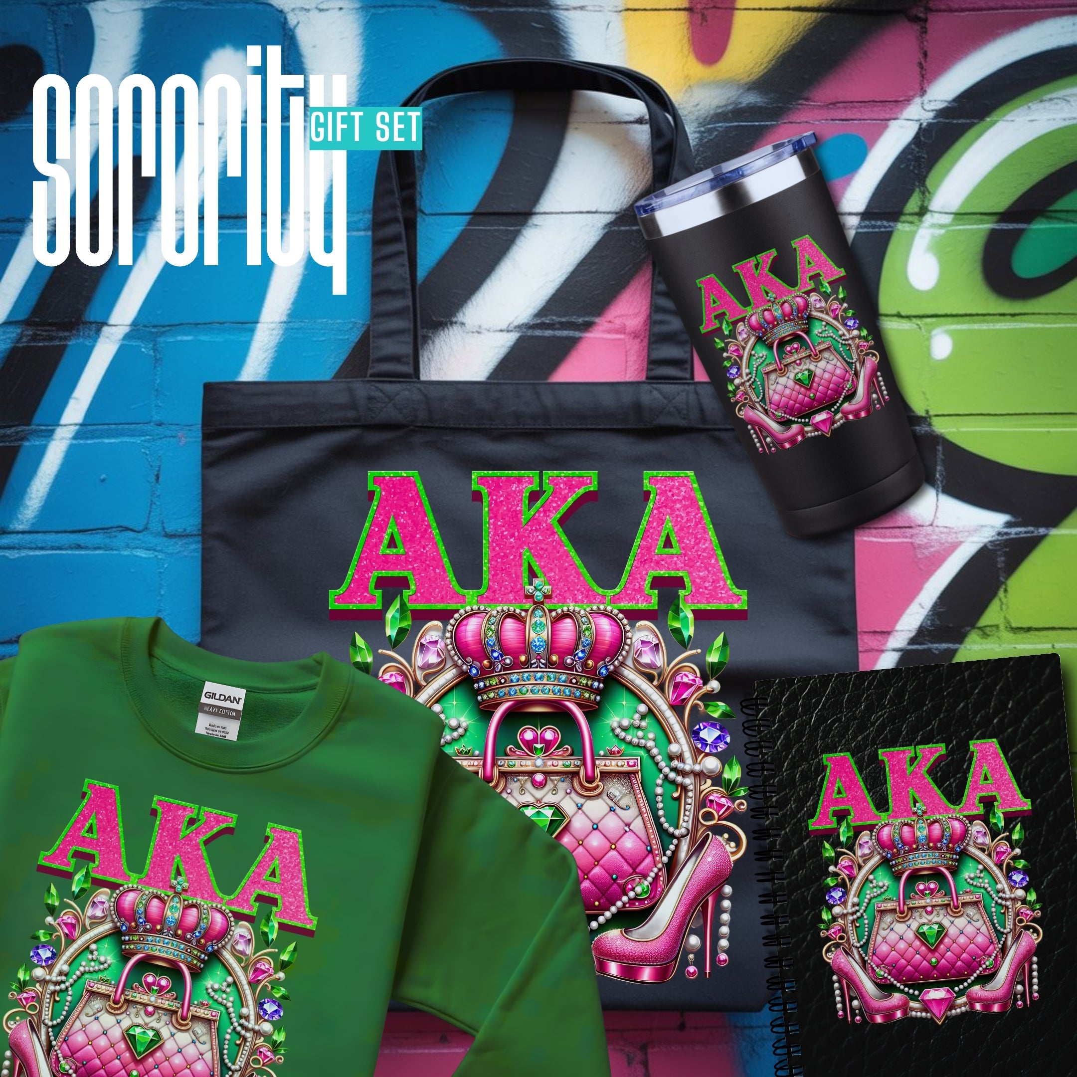 A Sorority gift set featuring multiple apparel and accessories with a matching graphic design. The set includes a black tote bag, a green t-shirt, a black tumbler, and a black spiral notebook, all decorated with a pink and green crown-and-lock graphic and the letters 'AKA'.