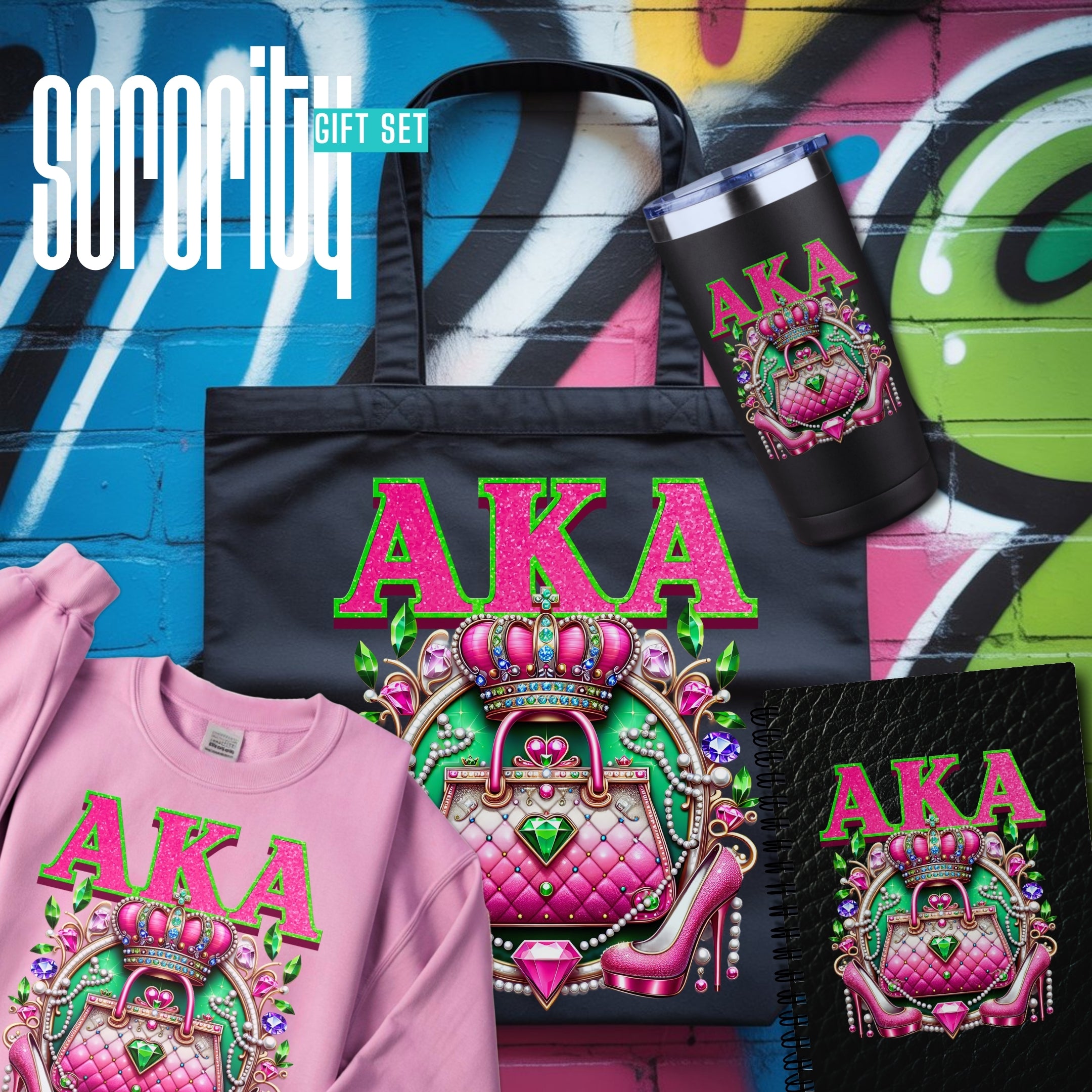 A Sorority gift set featuring a black tote bag, a pink sweatshirt, a black tumbler, and a black notebook, all decorated with a colorful pink and green graphic of a crown, quilted purse, and the letters 'AKA'.