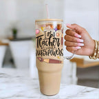 40oz Glass Tumbler with 'I am a Teacher, I have Superpowers' text held by a hand on a marble surface.
