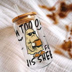 Clear tumbler with cartoon ghost design and text on a textured surface