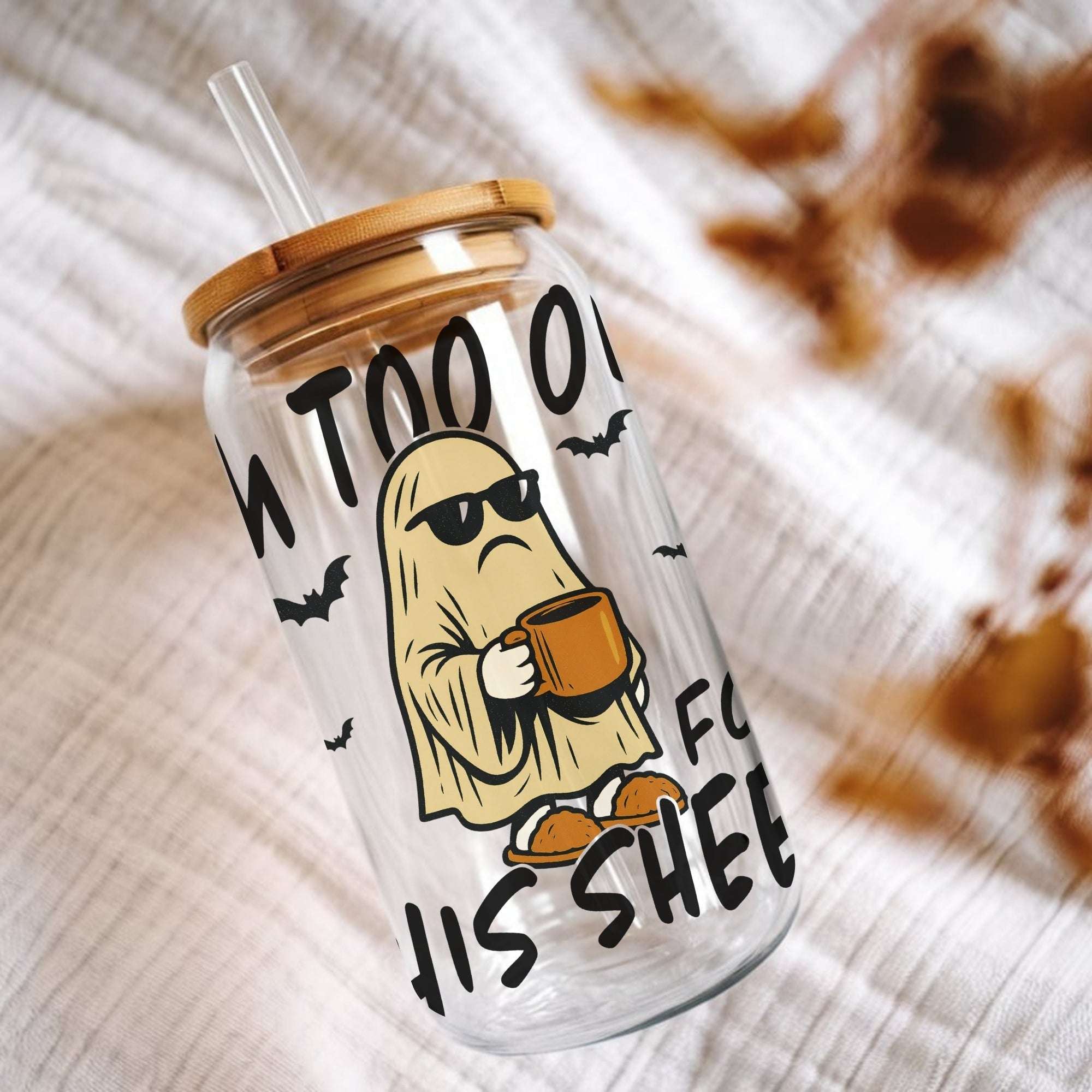 Clear tumbler with cartoon ghost design and text on a textured surface