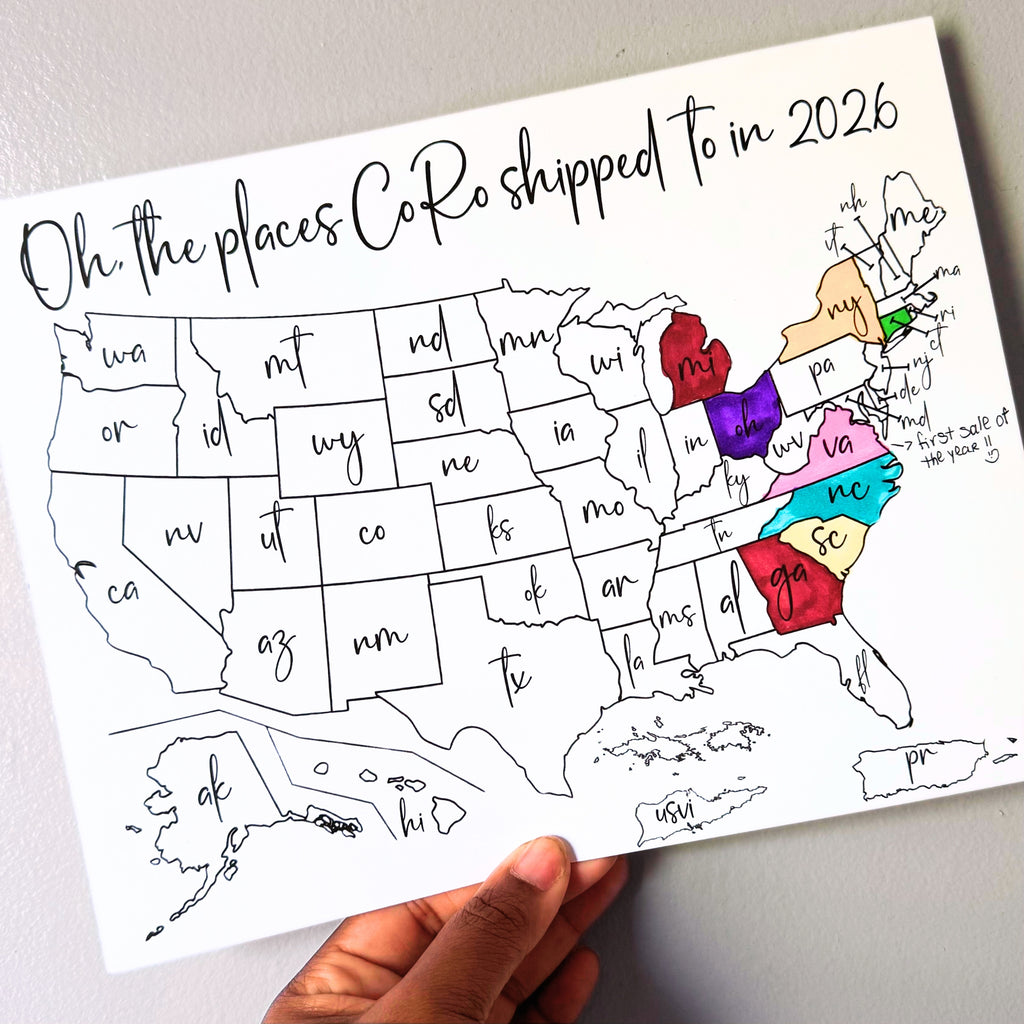 Map of the United States with colored boxes labeled 'Oh, the places CoRo shipped to in 2026' held by the owner's hand.