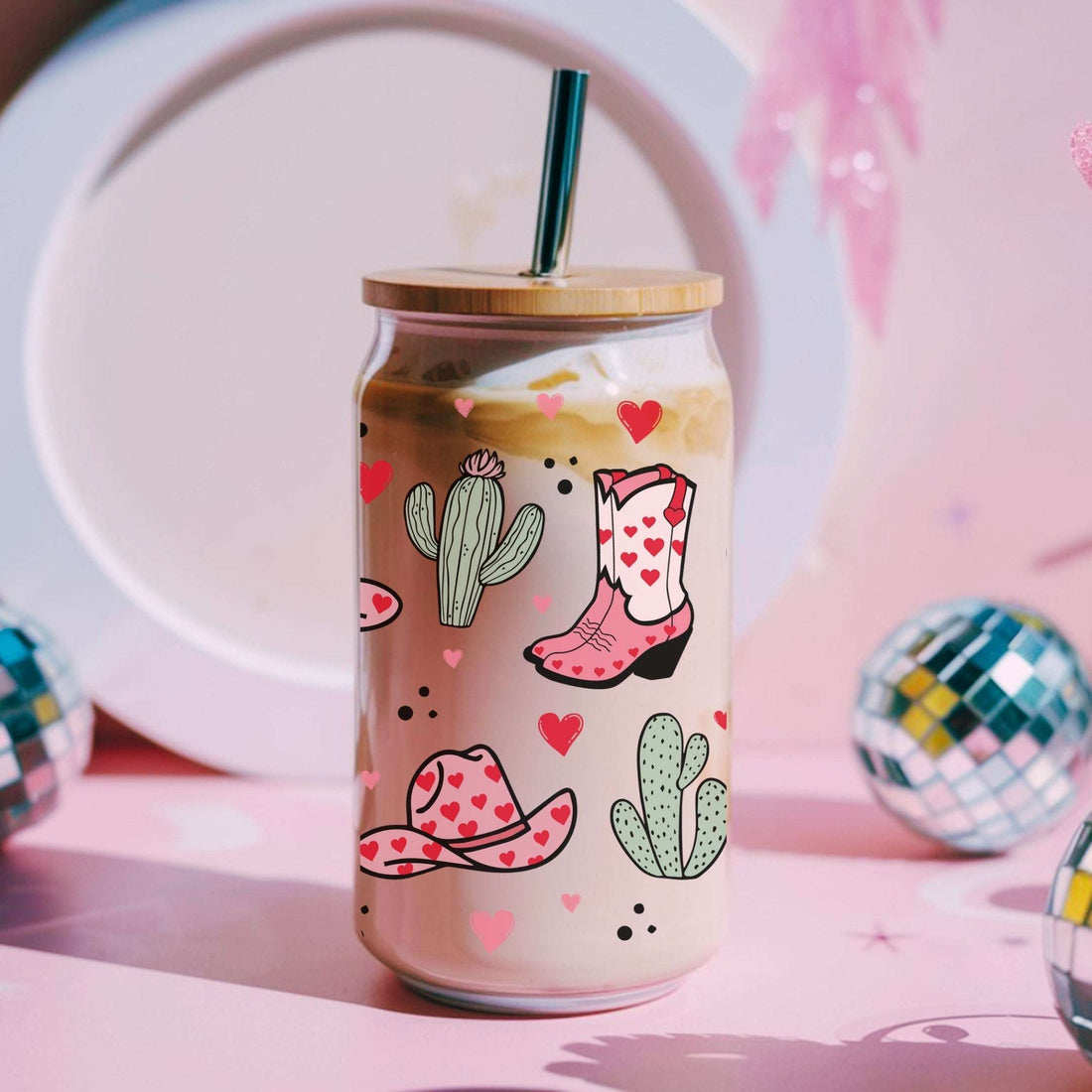 Tumbler with cowboy boot and cactus design on a pink background