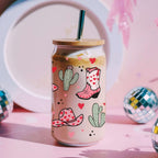 Tumbler with cowboy boot and cactus design on a pink background