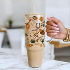 Tumbler with cowboy-themed design held by Nik's hand on a marble surface