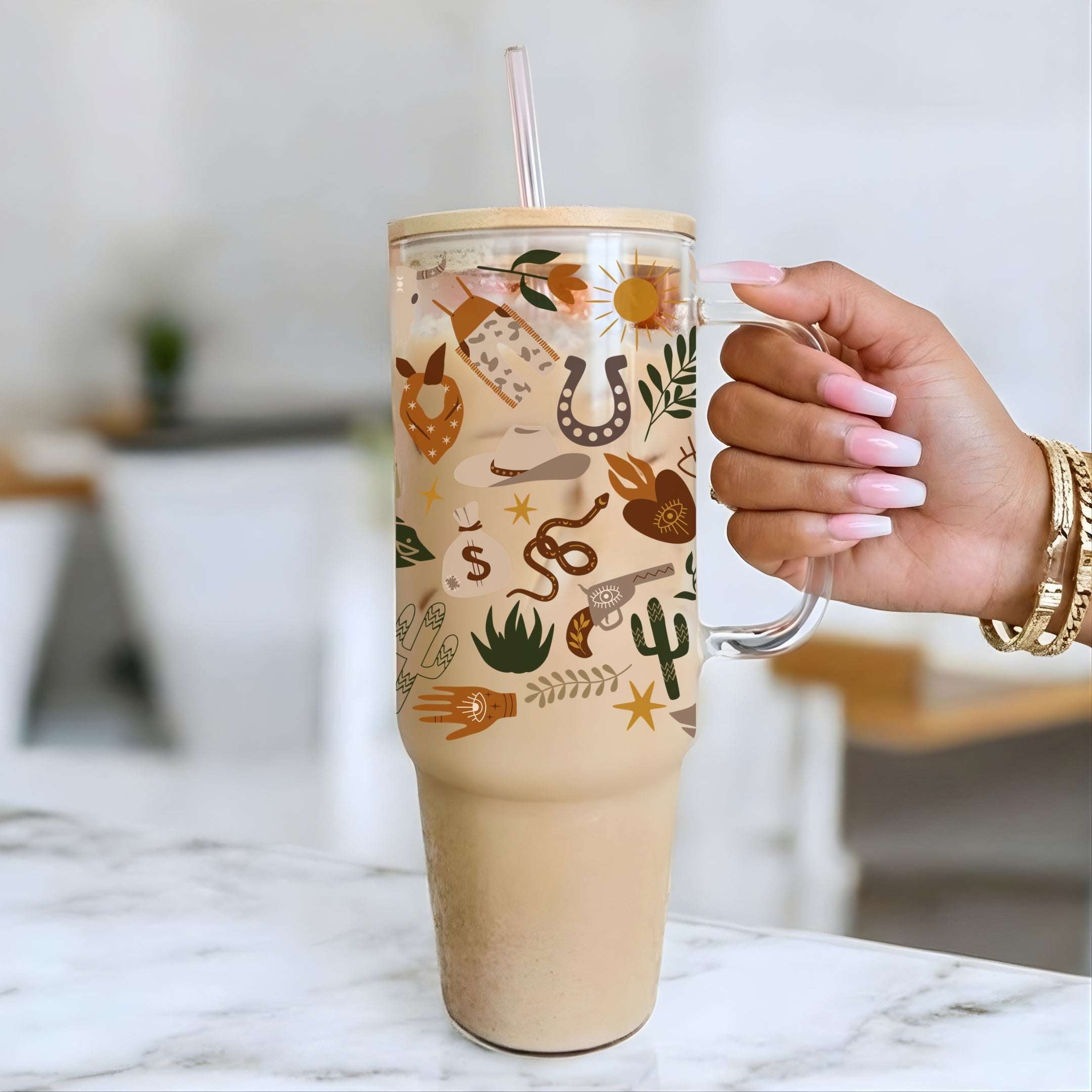 Tumbler with cowboy-themed design held by Nik's hand on a marble surface