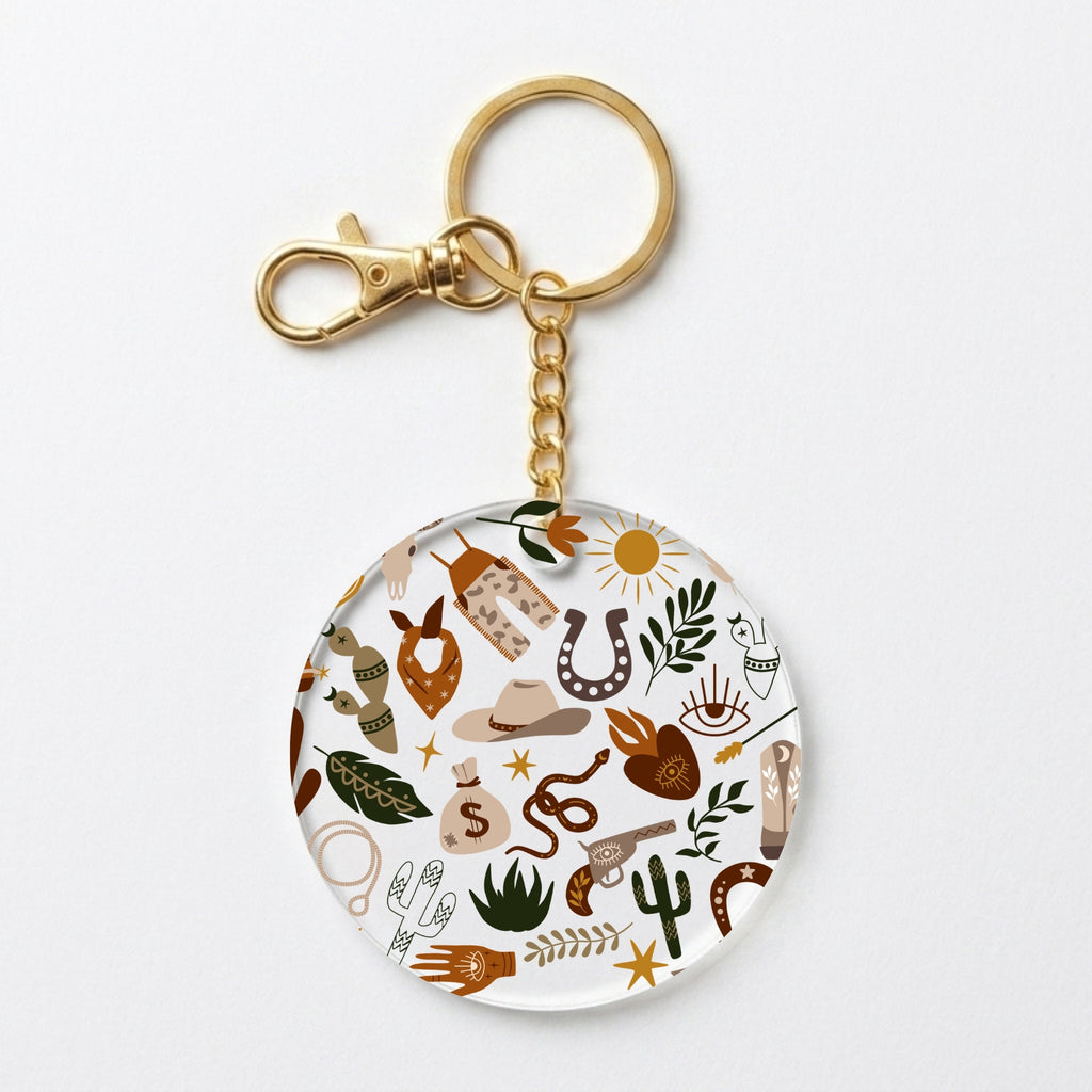 A round acrylic keychain charm featuring a western-themed doodle pattern with a gold-tone split ring and clasp, shown on a clean white background.