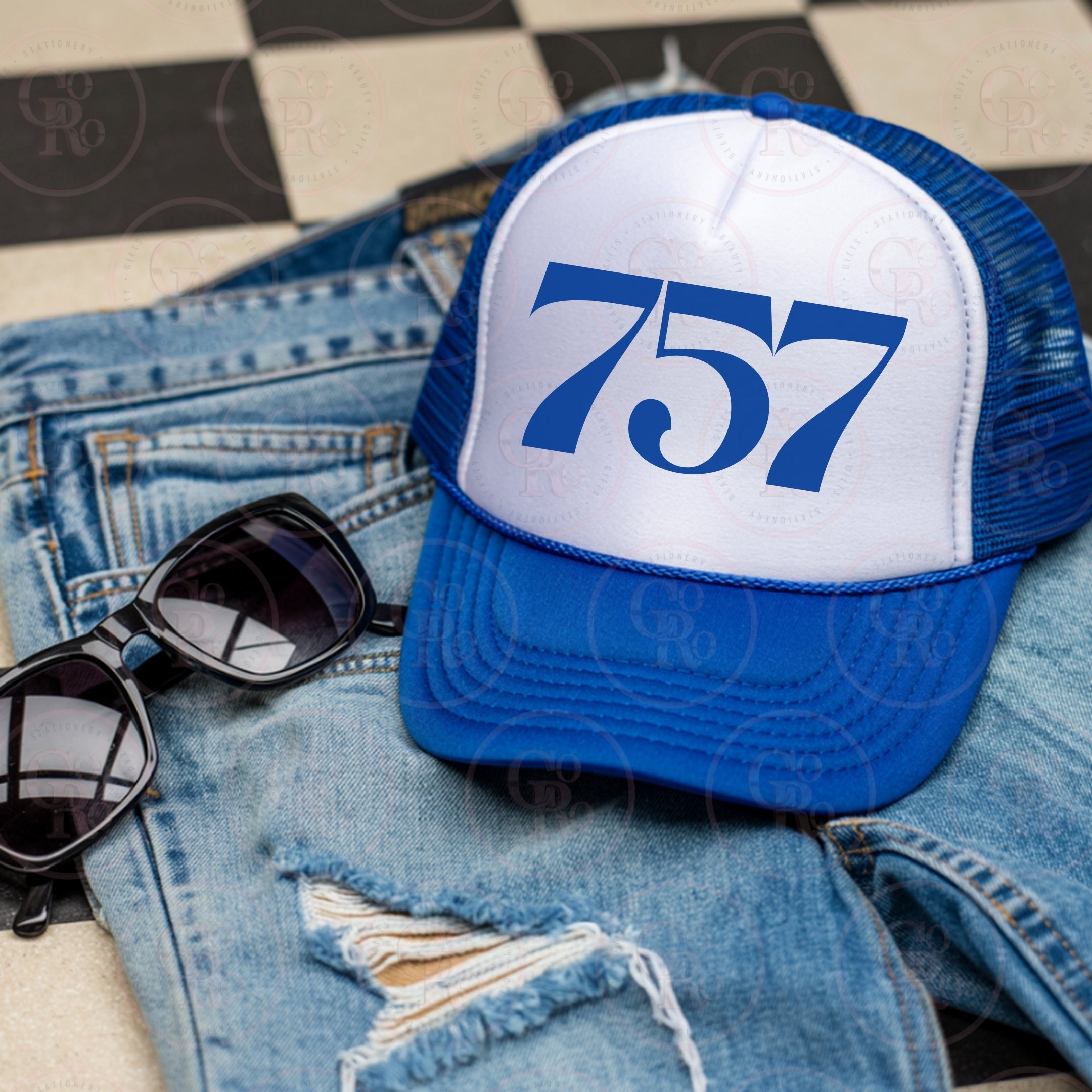 Blue and white trucker hat with area code '757' on a denim jacket and sunglasses