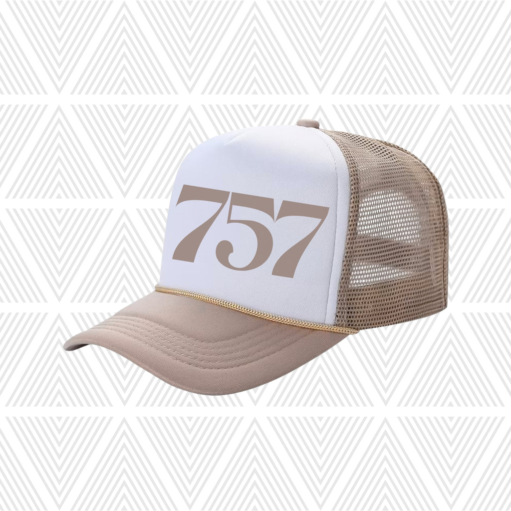 Tan and white cap with area code '757' design on a patterned background