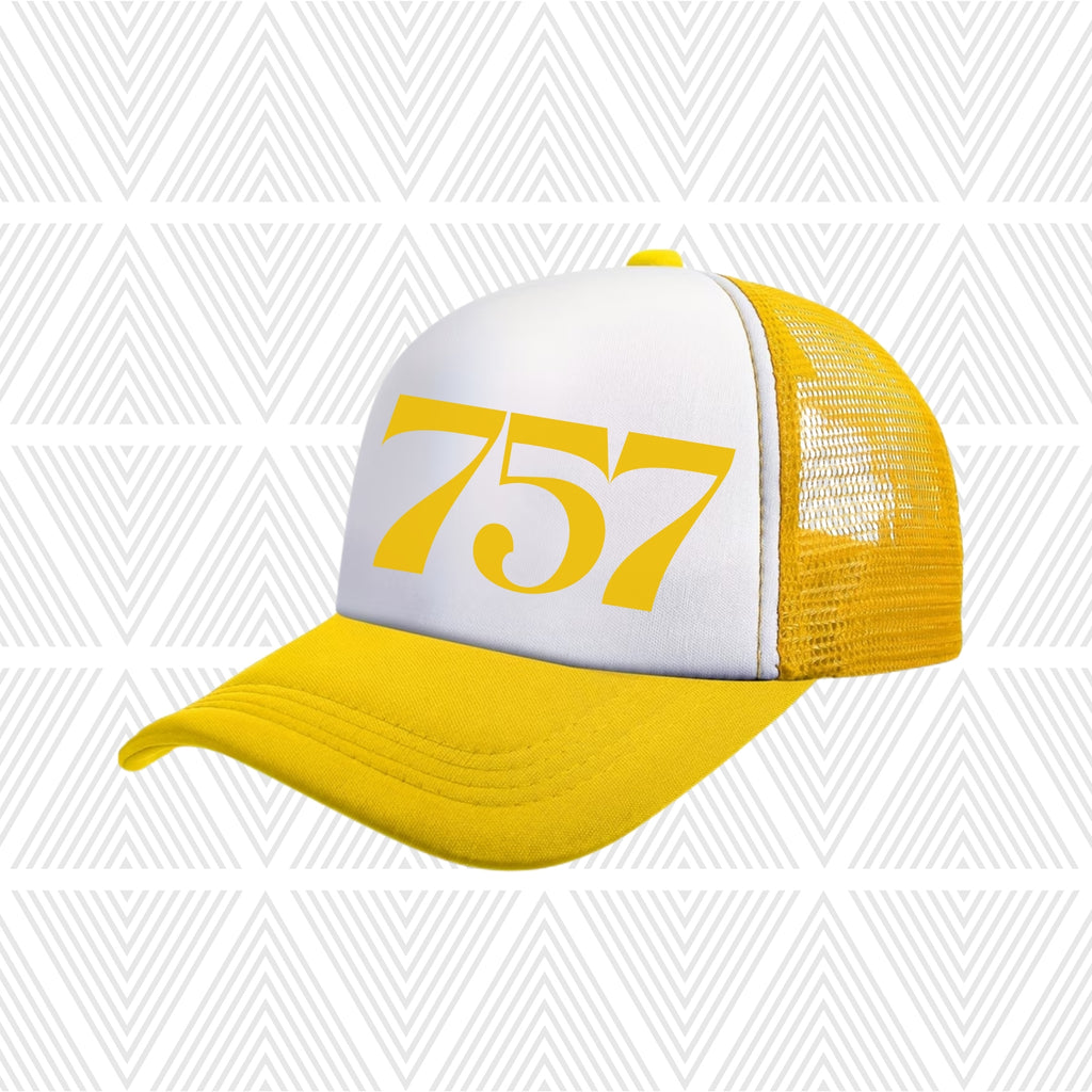Yellow and white cap with area code '757' printed on a geometric patterned background